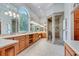 Large bathroom with stone tile, double sink vanity, big window and glass shower enclosure at 5040 Blackberry Ln, Buford, GA 30518