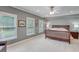 Spacious main bedroom with a ceiling fan, neutral walls, and multiple windows at 5040 Blackberry Ln, Buford, GA 30518