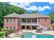 Classic brick home with a pool, spa, balcony, and inviting outdoor spaces at 5040 Blackberry Ln, Buford, GA 30518