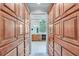 Large walk-in closet with custom wood shelving, and great lighting at 5040 Blackberry Ln, Buford, GA 30518