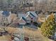 Aerial view of a brick house showing roof, mature trees, driveway, and landscaping at 735 Amberton Close, Suwanee, GA 30024