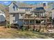 View of the back of the house showing a multi-level deck and backyard with green space at 735 Amberton Close, Suwanee, GA 30024