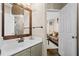 Bathroom featuring vanity, tile, mirror, and a doorway view of the living room at 735 Amberton Close, Suwanee, GA 30024