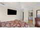 Bedroom featuring a TV, adjoining bathroom, and beige walls at 735 Amberton Close, Suwanee, GA 30024