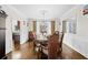 Formal dining room features hardwood floors and a decorative chandelier at 735 Amberton Close, Suwanee, GA 30024