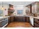 Gourmet kitchen featuring custom cabinetry, stainless steel appliances and a stone backsplash at 735 Amberton Close, Suwanee, GA 30024