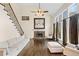 Bright living room featuring hardwood floors, a fireplace, and a staircase leading to the upper level at 735 Amberton Close, Suwanee, GA 30024