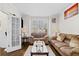 Comfortable living room with hardwood floors, neutral color and a doorway view of the entry at 735 Amberton Close, Suwanee, GA 30024