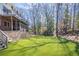 Expansive backyard featuring lush artificial turf, mature trees, a screened porch, and a play structure at 1835 Berkeley Ne Mews, Atlanta, GA 30329