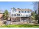 Back of house with a multi-level deck, screened porch, and a beautifully landscaped backyard with artificial turf at 1835 Berkeley Ne Mews, Atlanta, GA 30329