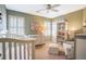 Cozy Bedroom with a white crib, changing table, accent chair and ottoman, bookcase filled with books and teddy bears at 1835 Berkeley Ne Mews, Atlanta, GA 30329