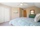 Bright bedroom with a ceiling fan, bed with patterned bedding, a bureau with mirror and closet at 1835 Berkeley Ne Mews, Atlanta, GA 30329