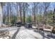 Outdoor deck with a grill, dining set, and wicker lounge furniture with natural wooded scenery at 1835 Berkeley Ne Mews, Atlanta, GA 30329