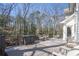 Outdoor deck with dining table and chairs, a grill, and wooded views for peaceful relaxation at 1835 Berkeley Ne Mews, Atlanta, GA 30329