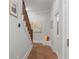 Hallway featuring tiled floor, wood stairs with white risers and a cushioned seating area at 1835 Berkeley Ne Mews, Atlanta, GA 30329