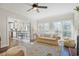 Bright and airy living room with a ceiling fan, hardwood floors, and a view into the dining area at 1835 Berkeley Ne Mews, Atlanta, GA 30329