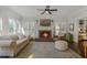 Cozy living room features a fireplace, neutral decor, and views to the outside at 1835 Berkeley Ne Mews, Atlanta, GA 30329