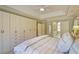 Large main bedroom closet with built-in shelving and drawers, hardwood floors, and ample space at 1835 Berkeley Ne Mews, Atlanta, GA 30329