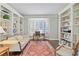 Home office with custom built-in bookshelves and large bay window with plantation shutters at 1835 Berkeley Ne Mews, Atlanta, GA 30329