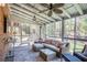 Relaxing screened porch with comfortable seating, ceiling fans, and views of the wooded backyard at 1835 Berkeley Ne Mews, Atlanta, GA 30329