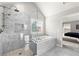 Elegant bathroom featuring a glass shower and soaking tub, illuminated by a window, with bedroom view at 2230 Rosemoore Walk, Marietta, GA 30062