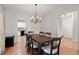 Elegant dining room with hardwood floors, a chandelier, and views into the kitchen at 2230 Rosemoore Walk, Marietta, GA 30062