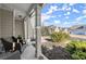 View of the covered front porch with comfortable seating and manicured landscaping at 2230 Rosemoore Walk, Marietta, GA 30062