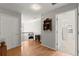 Inviting hallway with hardwood floors, chair, and an open doorway to a brightly lit room at 2230 Rosemoore Walk, Marietta, GA 30062