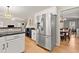 Kitchen with stainless steel refrigerator and a view into a dining area at 2230 Rosemoore Walk, Marietta, GA 30062