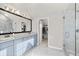 Main bathroom featuring double sinks, vanity, framed mirror, walk-in closet and glass shower at 2230 Rosemoore Walk, Marietta, GA 30062