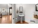 Stylish powder room boasts a pedestal sink, modern mirror and an entryway view at 2230 Rosemoore Walk, Marietta, GA 30062