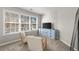 Sitting area with chairs and a blue dresser bathed in natural light from a large window at 2230 Rosemoore Walk, Marietta, GA 30062