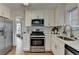 Modern kitchen with stainless steel appliances, subway tile backsplash, and ample counter space at 3260 Northcliff Dr, Suwanee, GA 30024