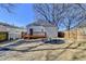 This backyard offers a wooden deck, a fire pit, gravel walkway and is fenced in for privacy at 543 Paines Nw Ave, Atlanta, GA 30318