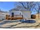 The beautiful backyard features a wooden deck and a fire pit surrounded by gravel, all within a fenced perimeter at 543 Paines Nw Ave, Atlanta, GA 30318