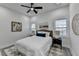 Bright bedroom with ceiling fan, white walls, modern decor, and windows at 543 Paines Nw Ave, Atlanta, GA 30318