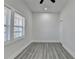 Bedroom featuring two windows with modern gray flooring and a ceiling fan at 543 Paines Nw Ave, Atlanta, GA 30318