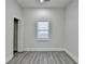 An airy bedroom is illuminated by a bright window and features sleek gray flooring at 543 Paines Nw Ave, Atlanta, GA 30318