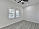 Bright bedroom with gray flooring, ceiling fan, and a window with blinds at 543 Paines Nw Ave, Atlanta, GA 30318