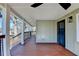 Inviting covered porch featuring wood flooring, ceiling fan, and a secure front entry at 543 Paines Nw Ave, Atlanta, GA 30318