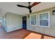 Inviting covered porch featuring wood flooring, ceiling fan, and a secure front entry at 543 Paines Nw Ave, Atlanta, GA 30318