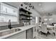 Kitchenette area with stainless sink, dishwasher, open to dining area, and modern lighting at 543 Paines Nw Ave, Atlanta, GA 30318