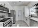 Well-equipped kitchen featuring stainless steel appliances, gray backsplash, and modern finishes at 543 Paines Nw Ave, Atlanta, GA 30318