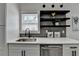 Kitchenette area with stainless steel sink and dishwasher, floating shelves, and quartz countertops at 543 Paines Nw Ave, Atlanta, GA 30318