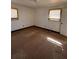 Empty bedroom with carpeted floors, two windows, and minimal lighting at 56 Pierce Rd, Hiram, GA 30141