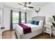 Inviting bedroom with a ceiling fan, cozy bed, and serene view through the window at 1300 Wichita Sw Dr, Atlanta, GA 30311