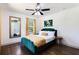 Chic bedroom features a green velvet bed, hardwood floors, and unique decorative elements at 1300 Wichita Sw Dr, Atlanta, GA 30311