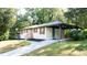 Charming exterior view of a home with a covered parking area and well-maintained landscaping at 1300 Wichita Sw Dr, Atlanta, GA 30311