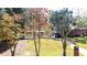 Charming single-Gathering home has a white exterior, mature landscaping, and a driveway at 1300 Wichita Sw Dr, Atlanta, GA 30311