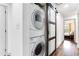 Modern laundry area with stacked washer and dryer, barn door to bedroom at 1300 Wichita Sw Dr, Atlanta, GA 30311